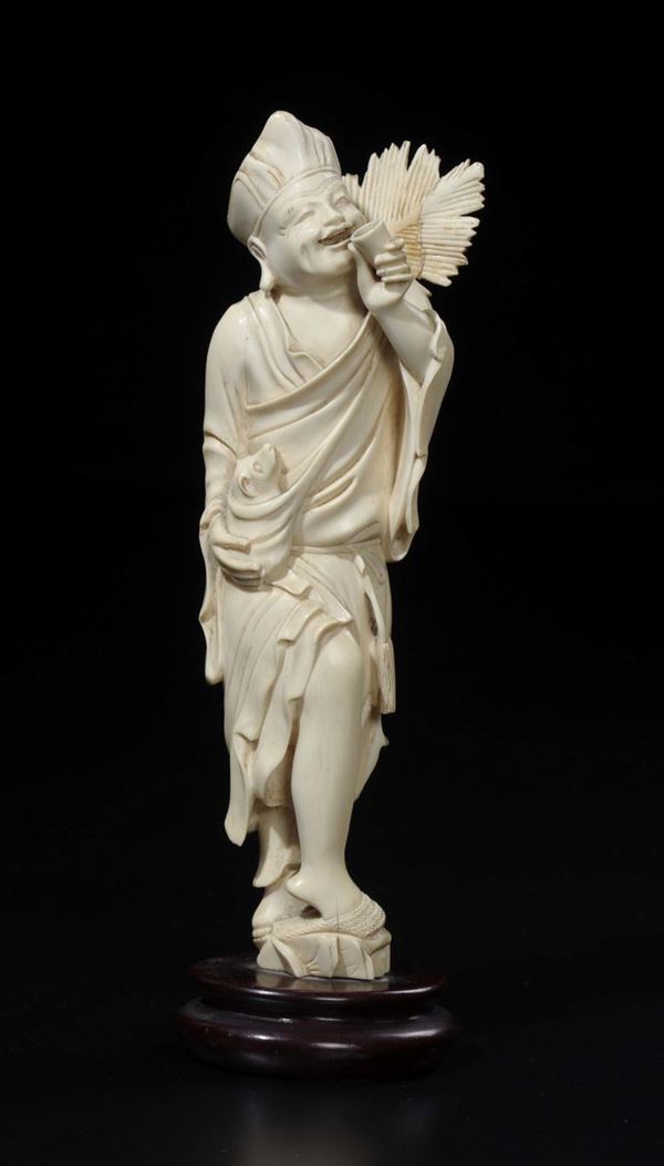 A carved ivory drunk farmer with small dog, Japan, early 20th century