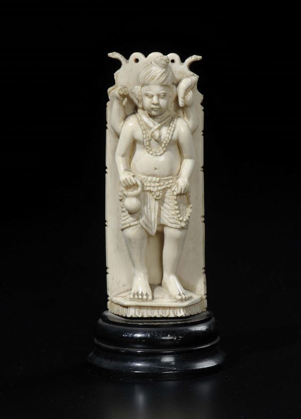 A carved ivory four-arms deity with necklace beads prayer and snake, India, early 20th century