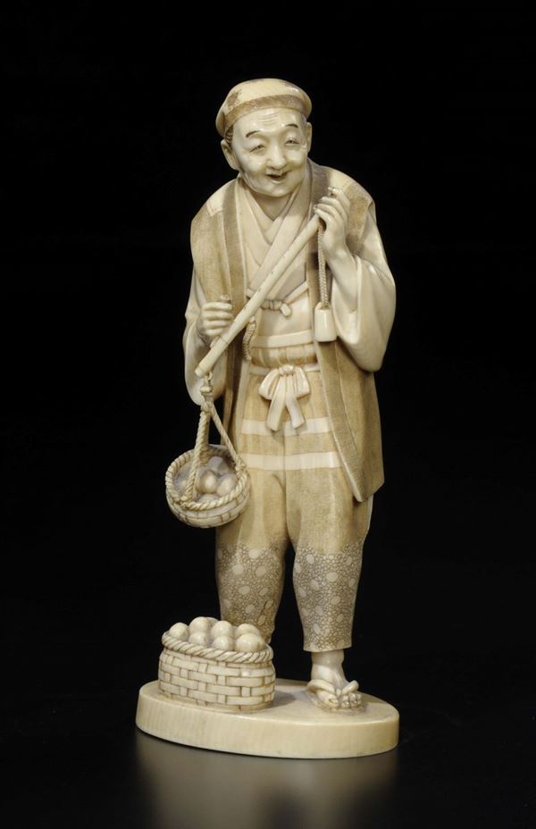 A carved ivory farmer with baskets of eggs, Japan, 19th century