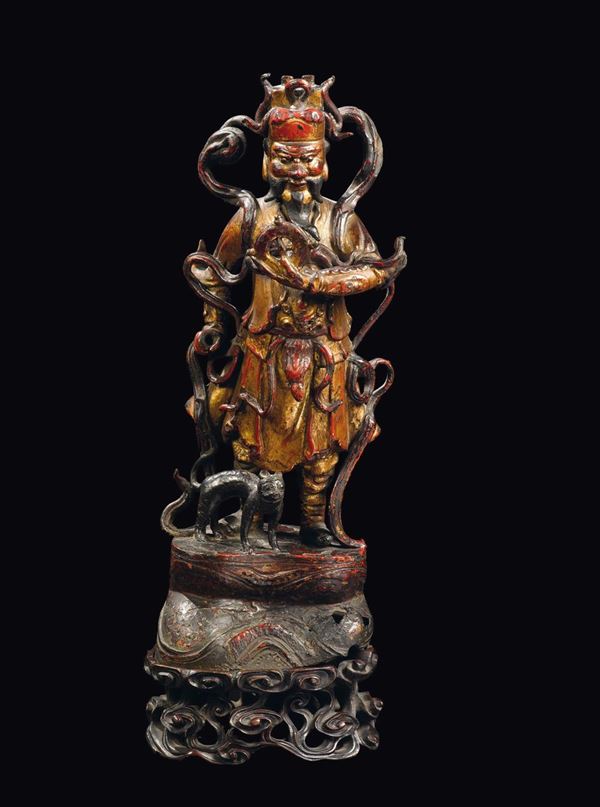A cold gilt bronze figure of Guandi with fretworked wooden base, China, Ming Dynasty, 16th century