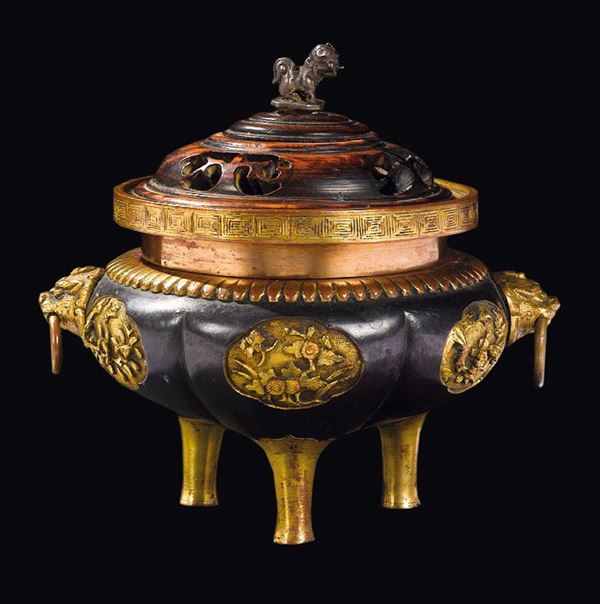 A burnished and gilt bronze tripod censer with fretworked wooden cover, China, Qing Dynasty, Qianlong Period (1736-1795)