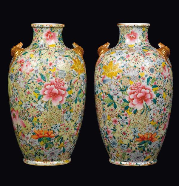 A pair of polychrome enamelled milleflor-ground porcelain vases with bats handles, China, Republic, 20th century