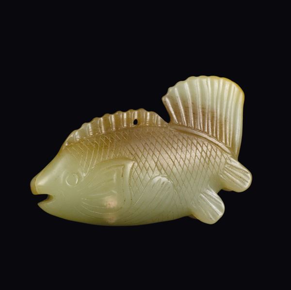 A yellow and russet jade fish shaped pendant, China, Yuan Dynasty (1279-1368)