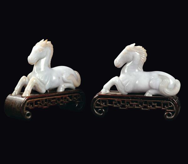 A pair of white and apple green jade horses, China, Qing Dynasty, 19th century
