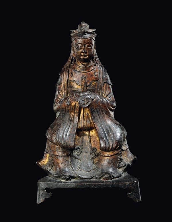 A semi-gilt bronze figure of sitting Guanyin, China, Ming Dynasty, 17th century