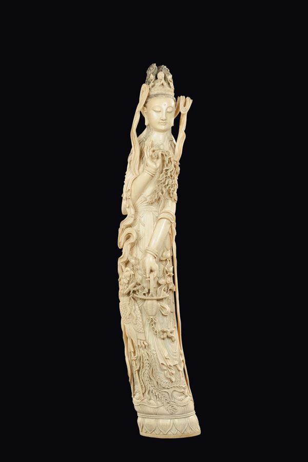 A large carved ivory figure of crowned Guanyin on lotus flower with basket and branches in bloom, China, early 20th century