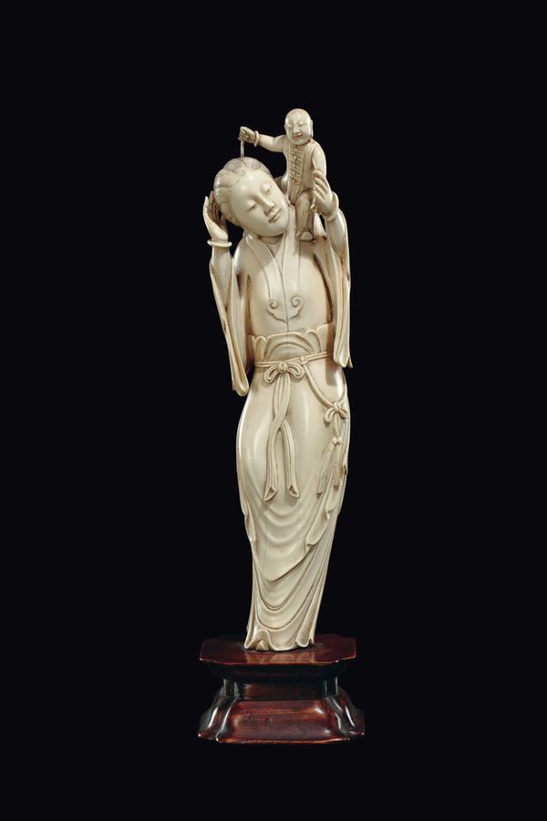 A carved ivory Guanyin and child group, China, Qing Dynasty, half of 19th century