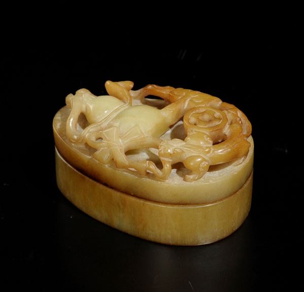 A yellow and russet jade box with a pumpkin in relief on the cover, China, Qing Dynasty, 19th century