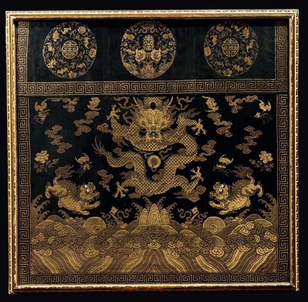 A silk cloth embroidered with a golden dragon and two Pho dogs beetween clouds, China, Qing Dynasty, 19th century