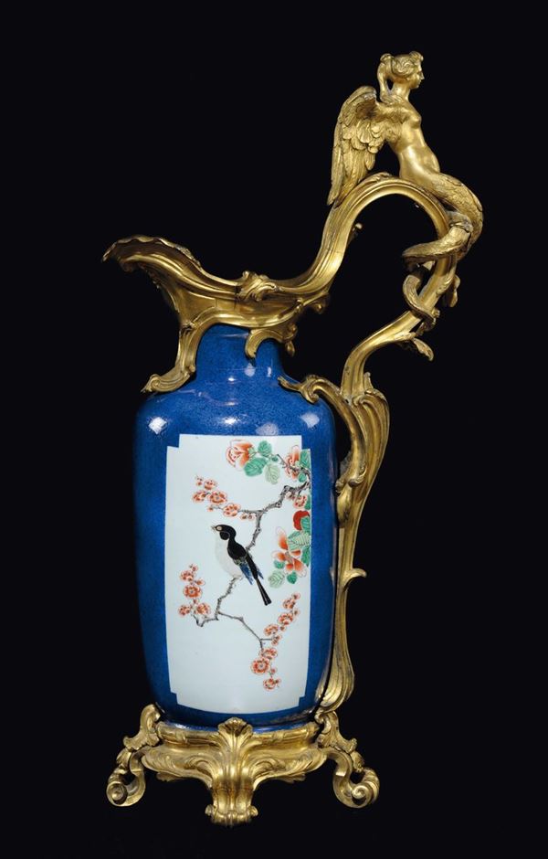 A Famille-Verte blue-ground vases with naturalistic decoration within reserves on a gilt bronze base and details, China, Qing Dynasty, Kangxi Period (1662-1722)