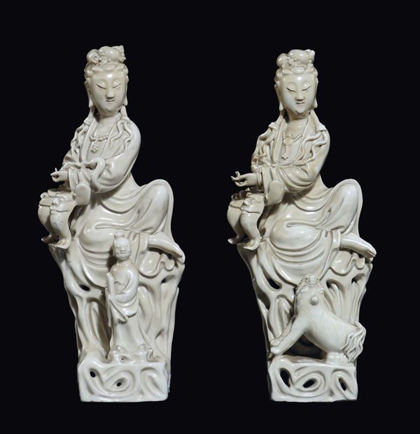 Two Blanc De Chine sitted Guanyin, one with a Pho dog and one with a child, China, early 20th century