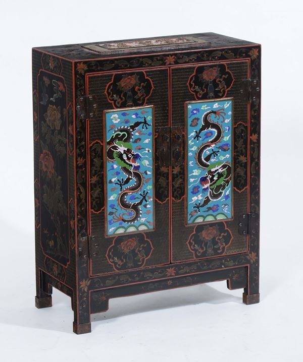 A lacquered wooden cabinet with two shutters depicting dragons, China, 20th century