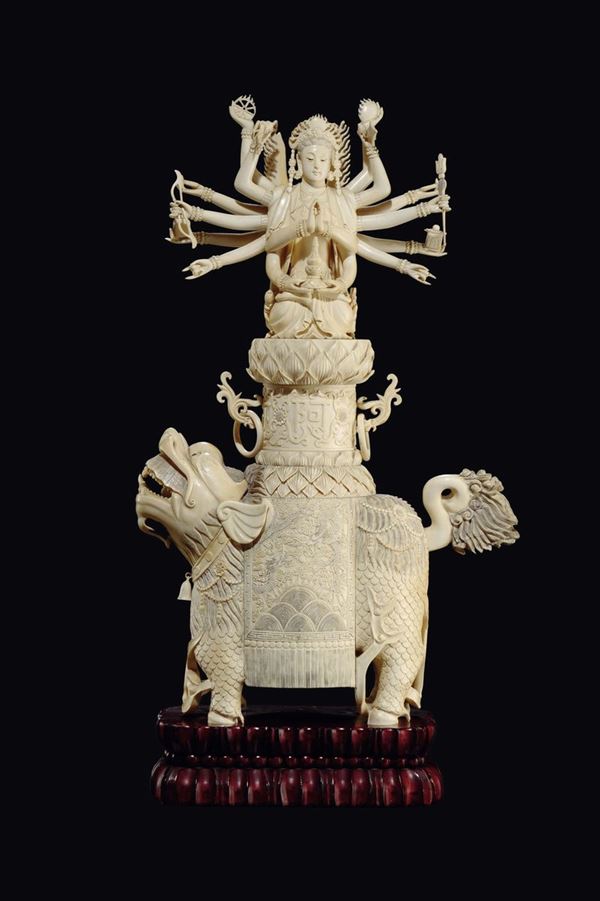 A carved ivory Pho dog carrying on his back a deity on lotus flower, China, early 20th century