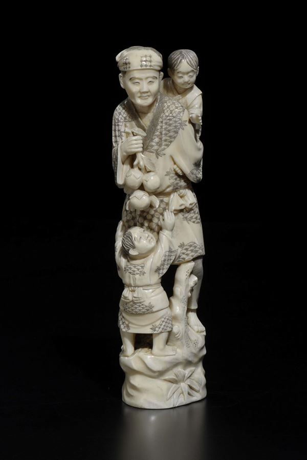 A carved ivory peasant with children, Japan, early 20th century