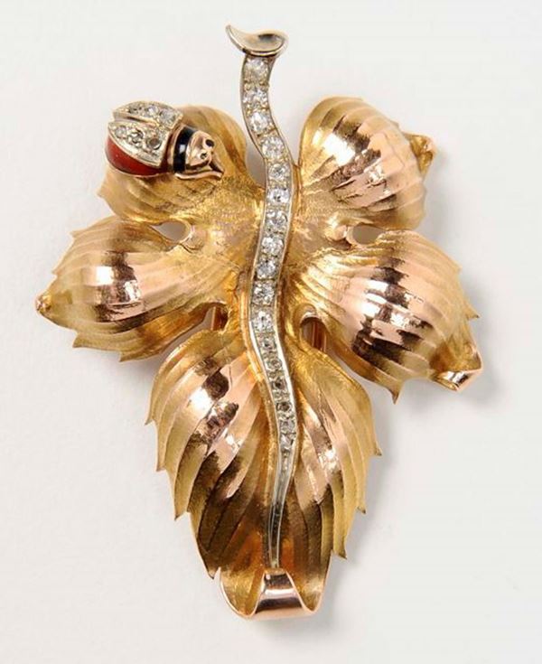 A gold and diamond brooch with ladybug