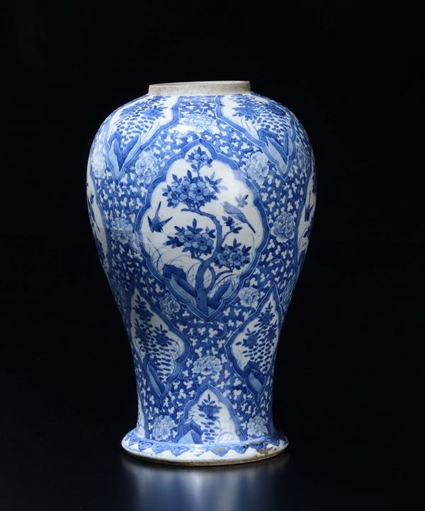 A blue and white vase with flowers within reserves, China, Qing Dynasty, 19th century