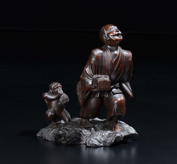 A carved wood farmer and monkey group, China, 20th century
