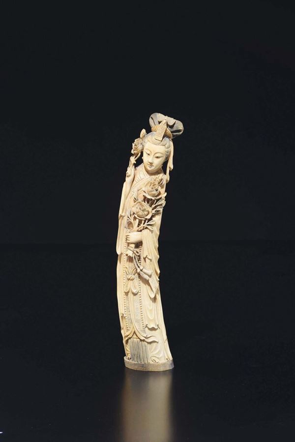 A carved ivory figure of Guanyin with roses, China, ealry 20th century