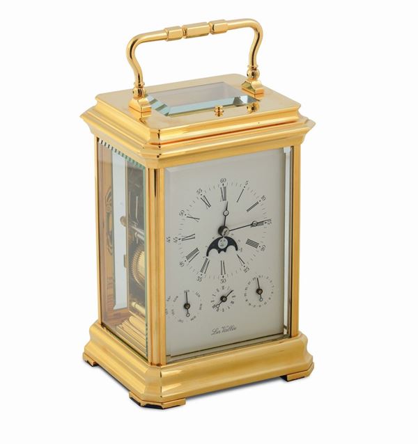 La Vallèe, Ref.81612001, gilt brass table clock with alarm, moonphases and calendar.Made in the 1990's.Accompanied by the original box, key charge and instruction booklet.