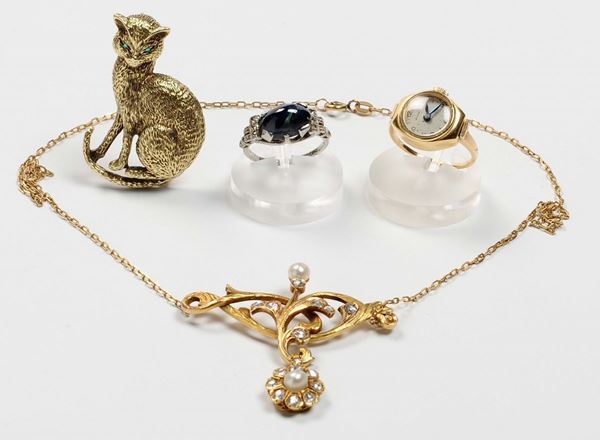A gold brooch, a pendant, a gold watch ring, and a sapphire ring