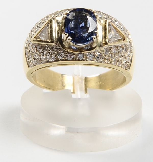 A sapphire, diamond and gold ring