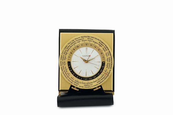 Luxor, gilt brass table clock with alarm and 24 hours indication with a revolving disc with the name of the cities of the world.Made in the 1960's