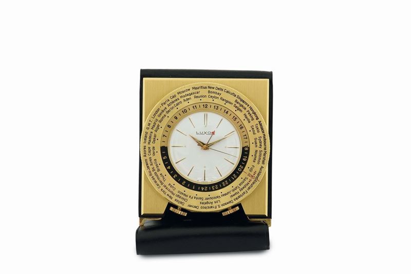 Luxor, gilt brass table clock with alarm and 24 hours indication with a revolving disc with the name of the cities of the world.Made in the 1960's  - Auction Watches and Pocket Watches - Cambi Casa d'Aste