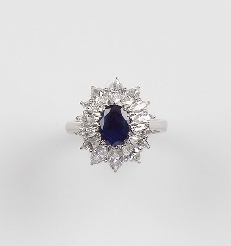 A sapphire and diamond ring. The sapphire is set with a marquese-cut diamonds and mounted in white gold 750/1000  - Auction Fine Jewels - Cambi Casa d'Aste
