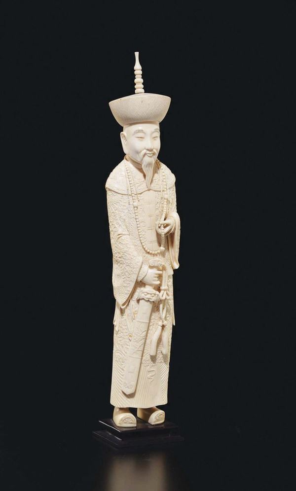 A carved ivory figure of dignitary with hat, China, early 20th century