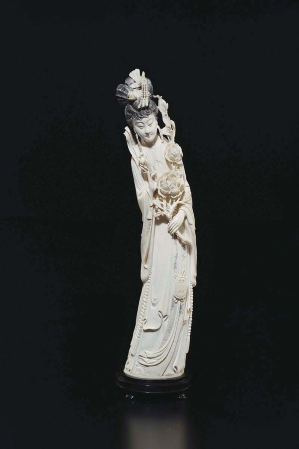 A carved ivory figure of Guanyin with black hair, China, early 20th century