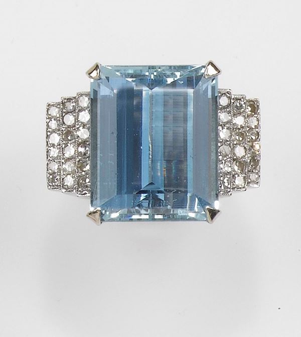An aquamarine and diamond ring. The aquamarine weighing approx. 35,00 carats is set with diamonds and mounted in white gold 750/1000