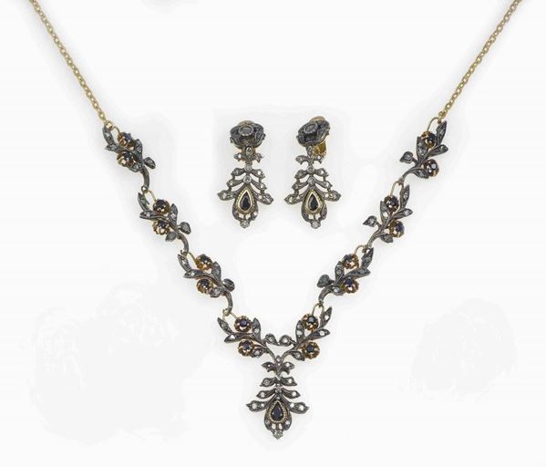 Gold and silver demi parure comprising a necklace and a pair of earrings