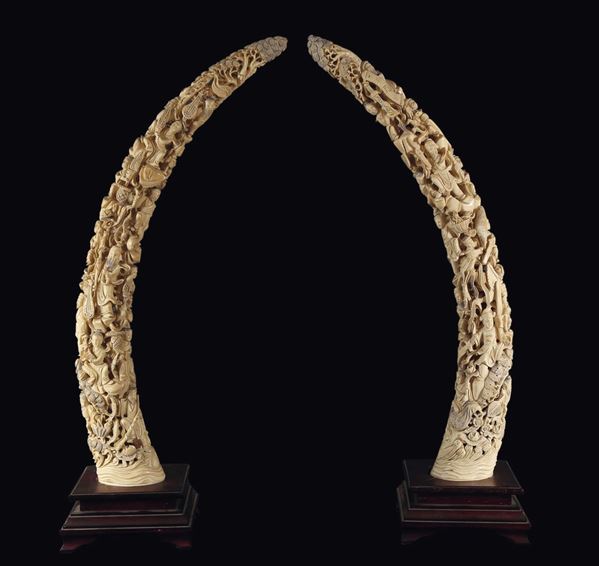 A pair of carved ivory fangs with figures, China, early 20th century