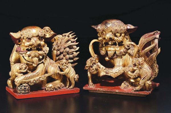 A pair of gilt wooden figures of Pho dogs, China, Qing Dynasty, 19th century