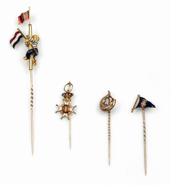 A collection of four tie pins