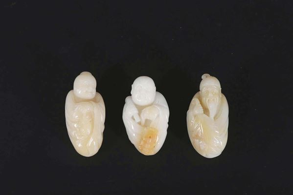 Three small white and russet jade figures of wise men, China, 20th century