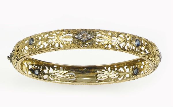 A gold and sapphire bangle