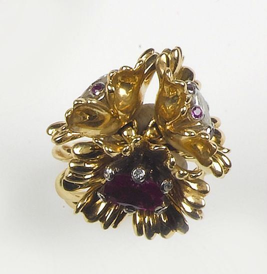 A flowers ruby and diamond ring. The Burma ruby and drop-cut diamond are mounted in yellow gold 750/1000