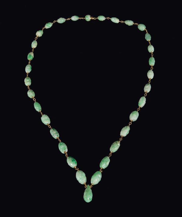 A green apple jade necklace, China, Qing Dynasty, 19th century