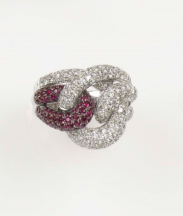 A diamond and ruby knot ring. The pavé- set diamonds and rubies are mounted in white gold 750/1000