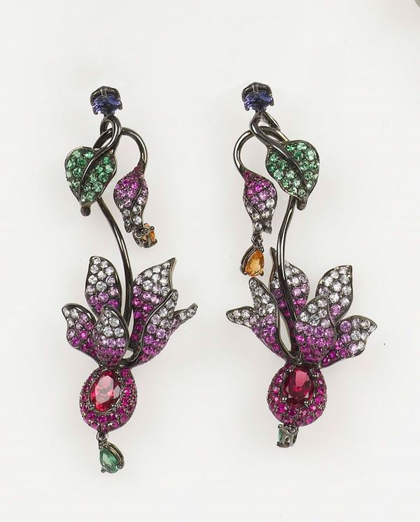 A garnet, multicolor sapphires, rubellite and tanzanite pendant earrings. Mounted in burnished gold