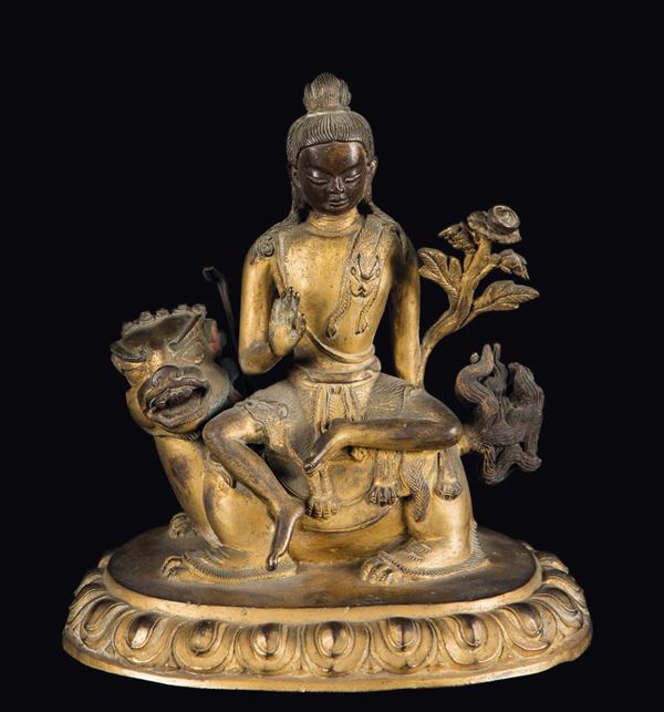 A gilt bronze figure of Buddha on a Pho dog, China, Qing Dynasty, 18th century