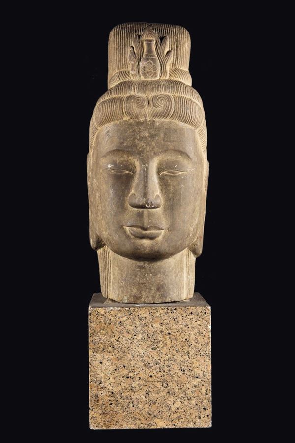 A stone Buddha's head with granite stand, Southeast Asia, 17th century