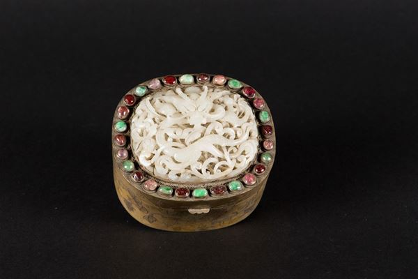 A gilt metal box with a white jade dragon plaque on the cover and semi-precious stones inlays, China, Yuan Dynasty (1279-1368)