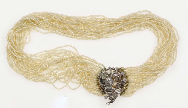 A pearl necklace. The necklace is composed of 22 strands of seed pearls and old-cut diamond clasp