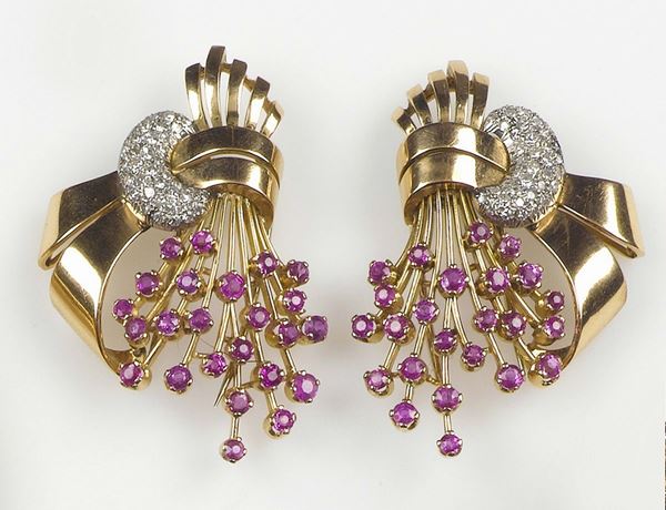 A couple of diamond and synthetic ruby clips. Mounted in yellow gold 750/1000