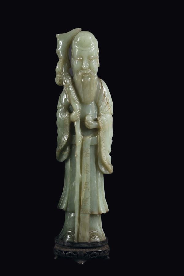 A Celadon jade figure of Shoulao with stick, China, Qing Dynasty, 19th century