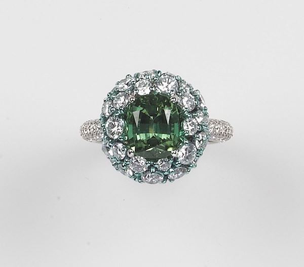 A Globo tourmaline and diamond ring. The green tourmaline weghing 2,90 carats is mounted in white gold 750/1000. Signed Brarda