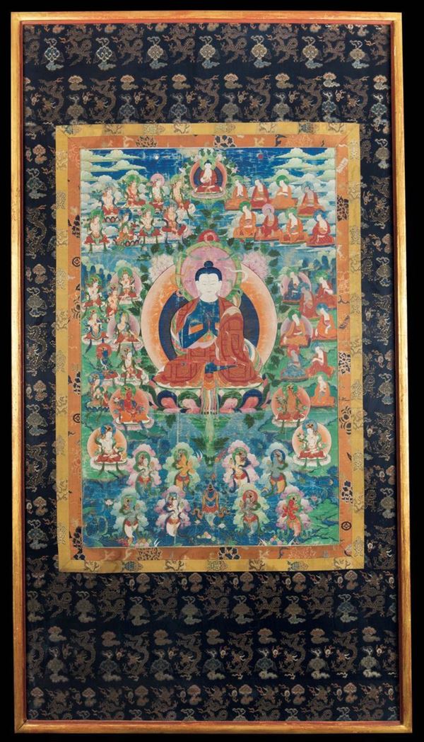 A framed gilt-highlighted silk tanka with a central figure of Buddha, Tibet, 18th century