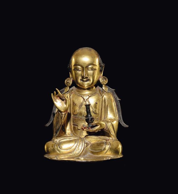 A gilt bronze figure of monk with vase, China, Ming Dynasty, 17th century